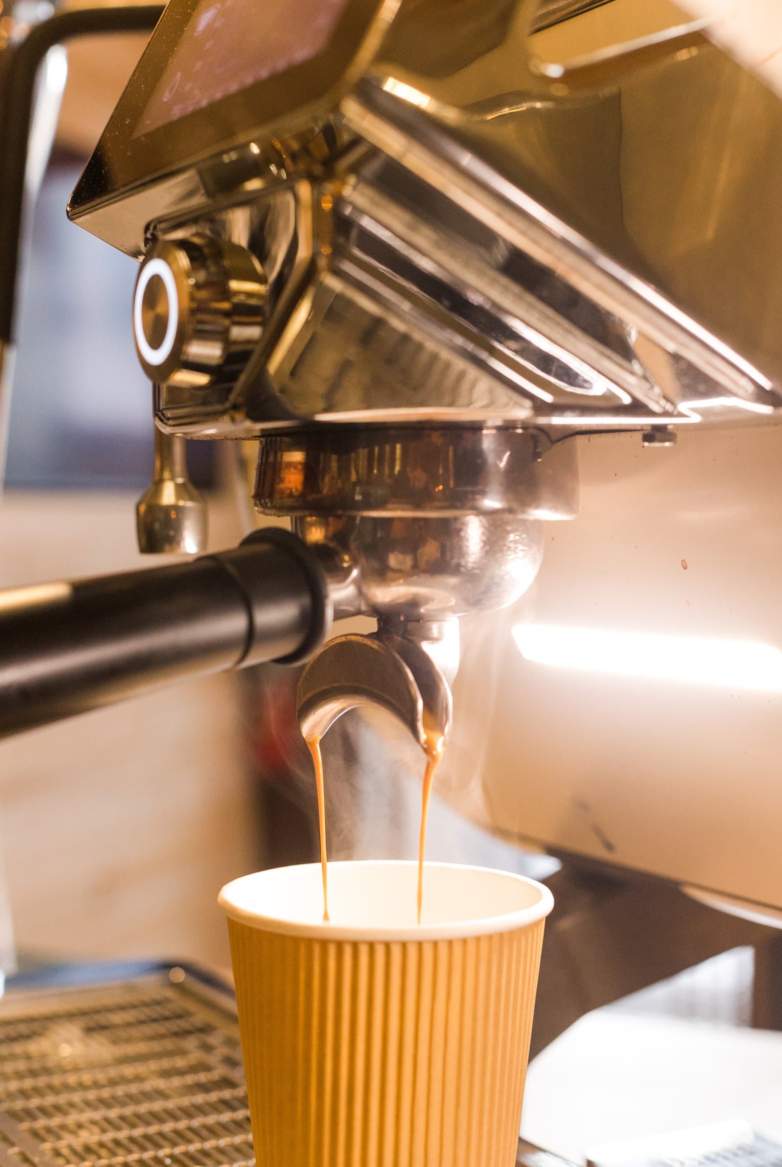 Espresso pouring from the machine into a cup